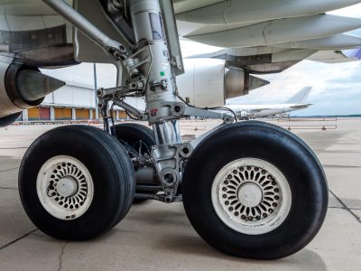 close up of airplane wheel parked at the airport