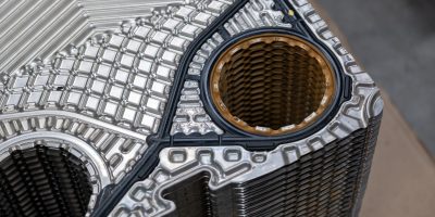 Detail of stainless steel heat exchanger plates with black gasket.